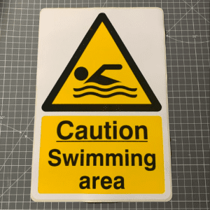 Caution swimming area sign