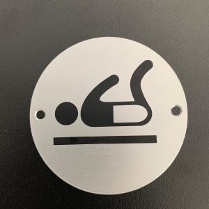 Brushed silver baby changing sign.