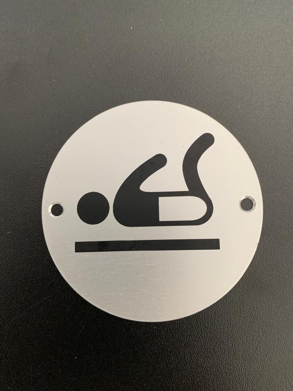 Brushed silver baby changing sign.