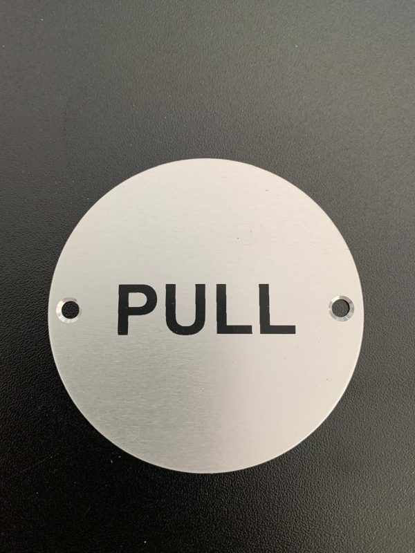 Brushed silver pull sign with screw holes.